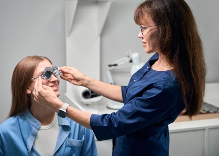 doctor-optometrist-fitting-trial-frame-on-patient-2025-03-08-05-21-38-utc-min